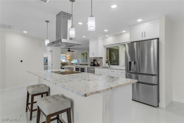 5305 SW 25th Ct, Cape Coral, FL 33914 - kitchen with appliances with stainless steel finishes, island exhaust hood, baseboards, white cabinetry, and recessed lighting