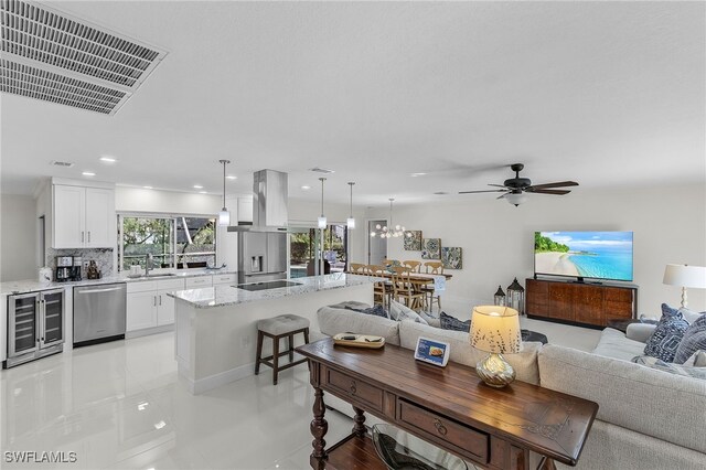 5305 SW 25th Ct, Cape Coral, FL 33914 - living room featuring beverage cooler, ceiling fan, light tile patterned floors, recessed lighting, and a chandelier