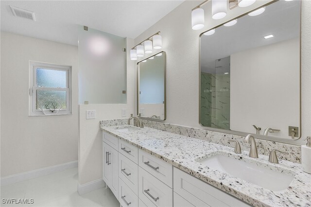 5305 SW 25th Ct, Cape Coral, FL 33914 - full bathroom with a marble finish shower, double vanity, and baseboards