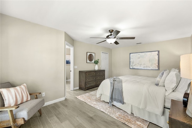 bedroom with visible vents, baseboards, light wood-type flooring, a closet, and a ceiling fan