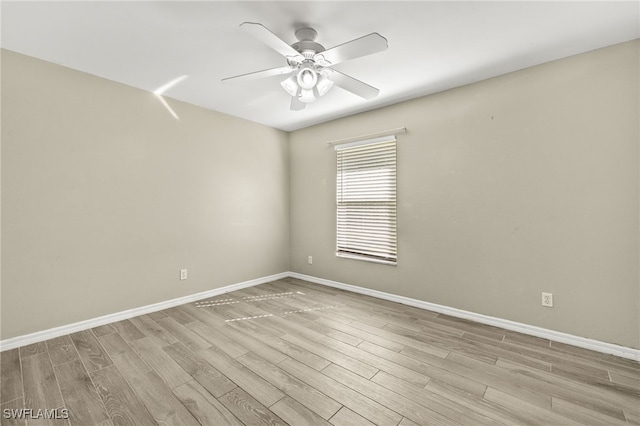 814 Louis Ave, Lehigh Acres, FL 33972 - empty room featuring a ceiling fan, light wood finished floors, and baseboards