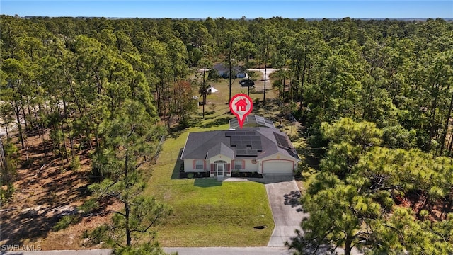 birds eye view of property with a forest view