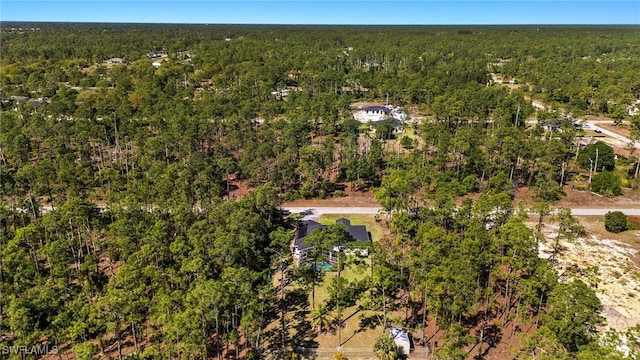 aerial view featuring a wooded view