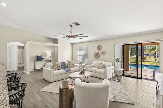 living room with a healthy amount of sunlight, wood finished floors, visible vents, and ceiling fan