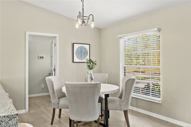 dining area featuring a notable chandelier, plenty of natural light, and baseboards