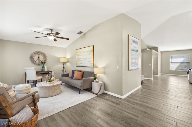 living room with visible vents, wood finished floors, baseboards, lofted ceiling, and ceiling fan