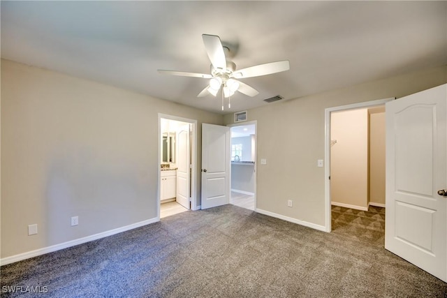 unfurnished bedroom with a ceiling fan, carpet flooring, visible vents, and baseboards