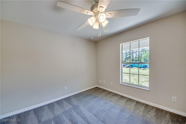 spare room with carpet floors, a ceiling fan, and baseboards