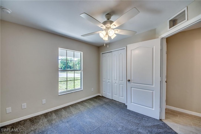 unfurnished bedroom featuring a ceiling fan, baseboards, visible vents, and carpet flooring