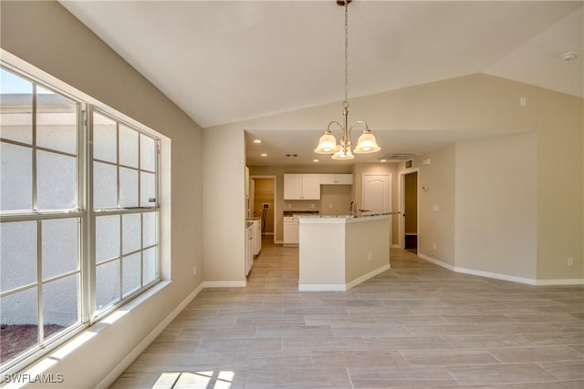 kitchen featuring white cabinetry, baseboards, vaulted ceiling, hanging light fixtures, and an inviting chandelier