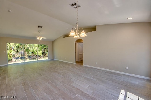 empty room featuring arched walkways, lofted ceiling, visible vents, light wood-type flooring, and ceiling fan with notable chandelier