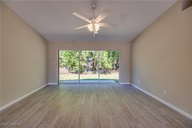 unfurnished room with wood finished floors, a ceiling fan, and baseboards