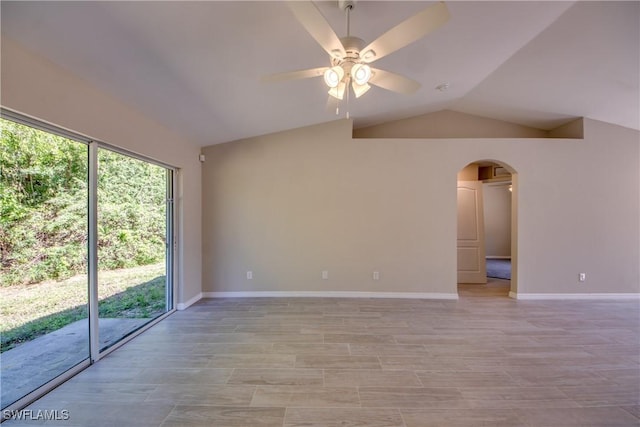 unfurnished room with lofted ceiling, plenty of natural light, arched walkways, and a ceiling fan