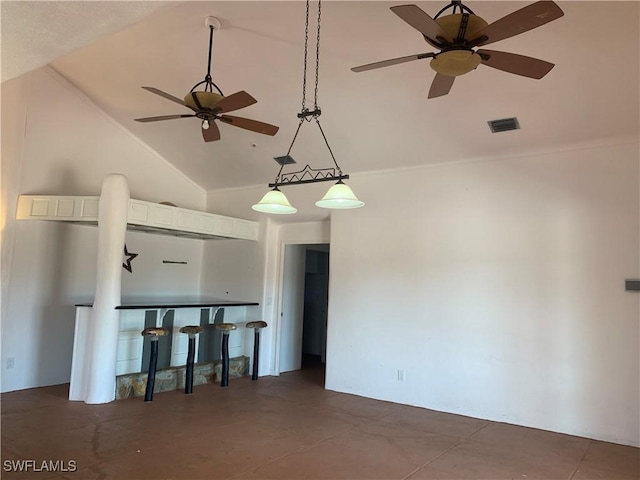 spare room featuring ceiling fan, high vaulted ceiling, and visible vents