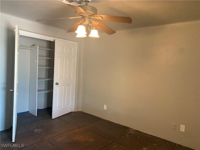 unfurnished bedroom with a ceiling fan and a closet