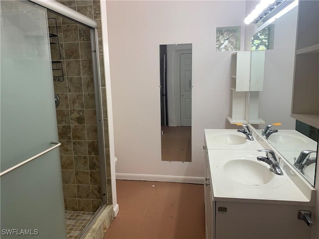 full bathroom with double vanity, a stall shower, and a sink