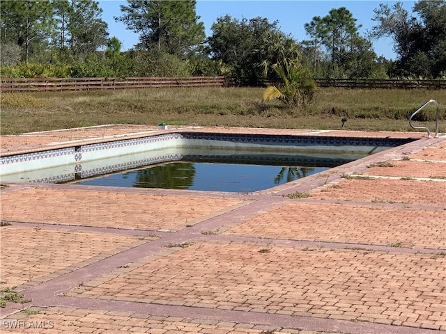 view of swimming pool featuring fence