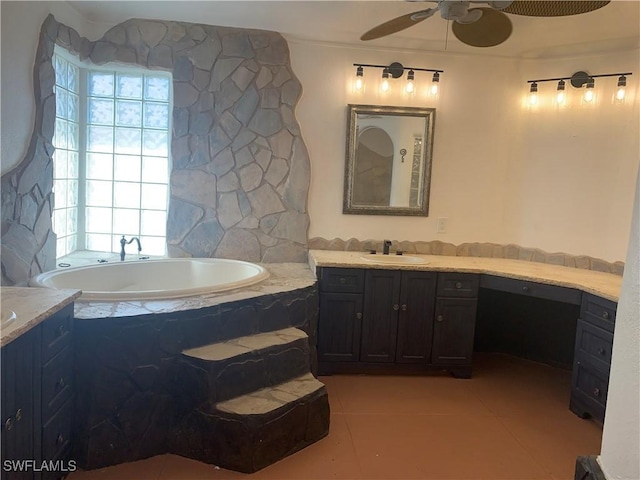 full bathroom featuring tile patterned flooring, a garden tub, plenty of natural light, and vanity