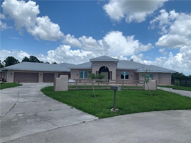 view of front facade with concrete driveway, a front lawn, a fenced front yard, and stucco siding