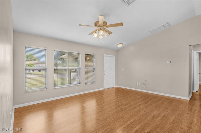 unfurnished room featuring ceiling fan, wood finished floors, visible vents, and baseboards