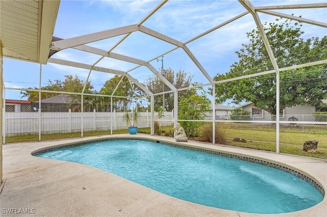 view of pool featuring a lawn, a fenced backyard, a fenced in pool, and a lanai