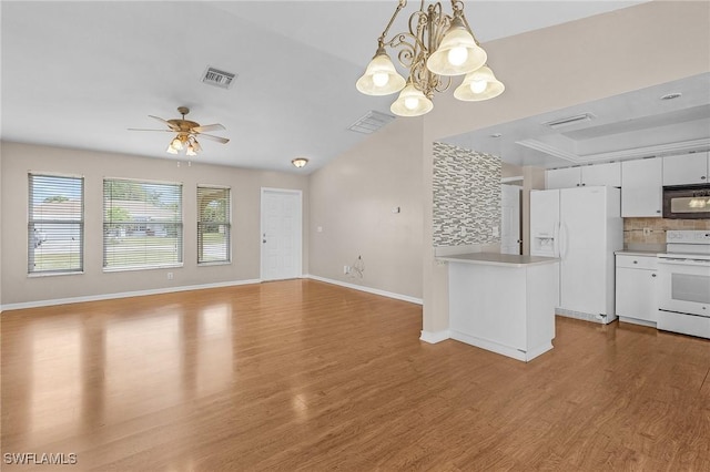 kitchen with white appliances, tasteful backsplash, light wood finished floors, visible vents, and white cabinetry