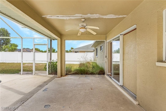 unfurnished sunroom with a ceiling fan