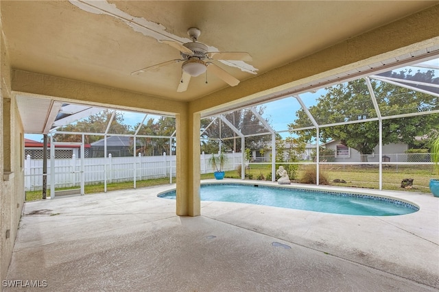 view of swimming pool featuring a patio area, a fenced backyard, and glass enclosure