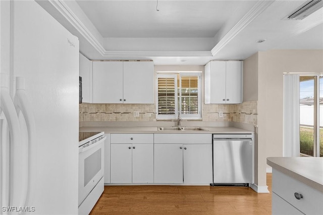 kitchen featuring white appliances, visible vents, a wealth of natural light, and a sink