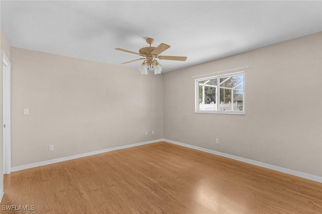 unfurnished room featuring a ceiling fan, light wood-type flooring, and baseboards