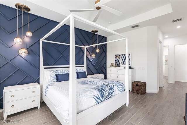 bedroom with wood finish floors, visible vents, and recessed lighting