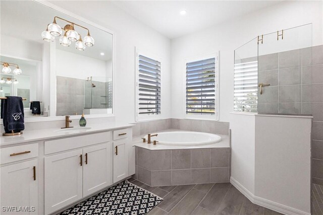 bathroom featuring recessed lighting, a garden tub, vanity, and a walk in shower