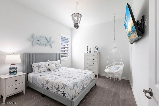 bedroom featuring wood finish floors and baseboards