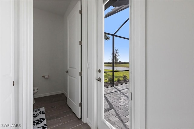 doorway to outside with wood finish floors and baseboards