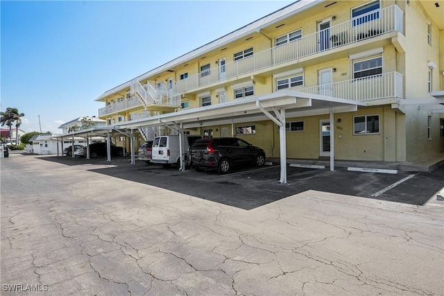 view of building exterior featuring covered parking