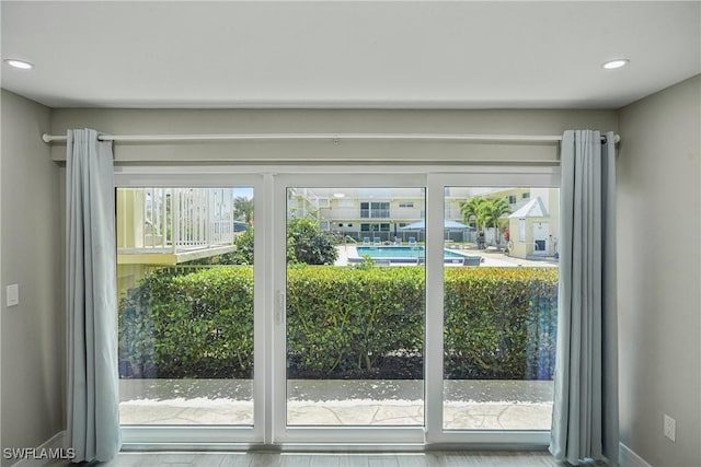 entryway with baseboards and recessed lighting