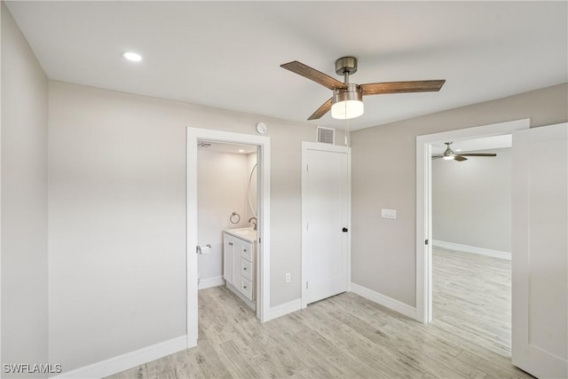 unfurnished bedroom featuring light wood-style floors, visible vents, ceiling fan, and baseboards