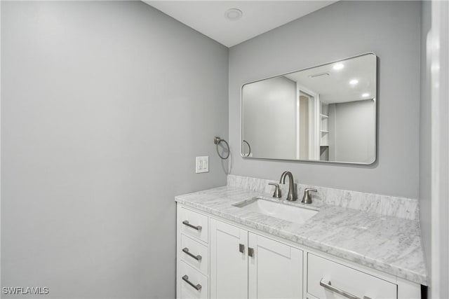 bathroom with recessed lighting and vanity