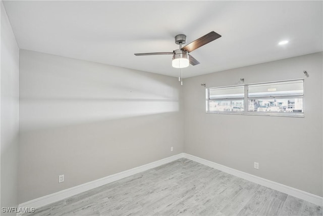 unfurnished room featuring ceiling fan, baseboards, and wood finished floors