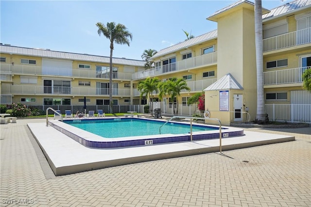 view of swimming pool with fence