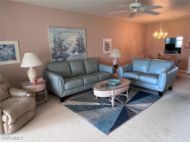 living room with ceiling fan with notable chandelier and carpet flooring