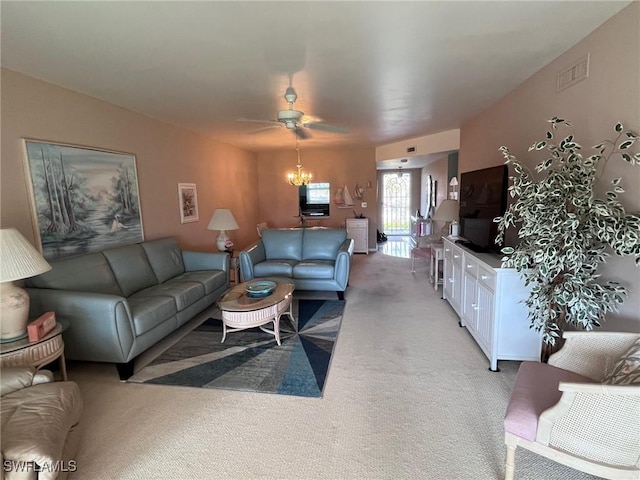 living area featuring light carpet, ceiling fan with notable chandelier, and visible vents