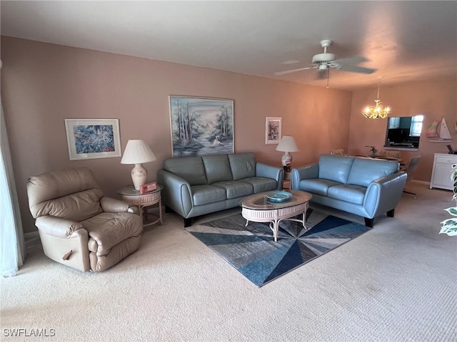 carpeted living area with ceiling fan with notable chandelier