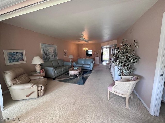 living room with ceiling fan, carpet floors, and baseboards