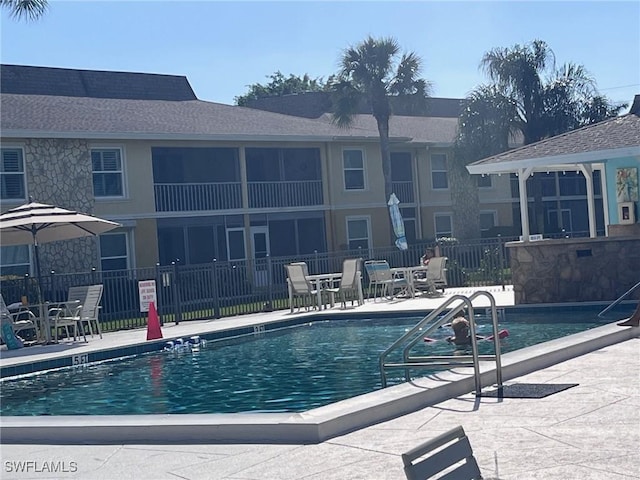 view of pool featuring a patio and fence