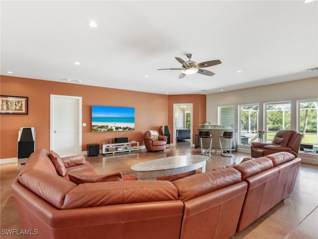 living room featuring ceiling fan, baseboards, and recessed lighting