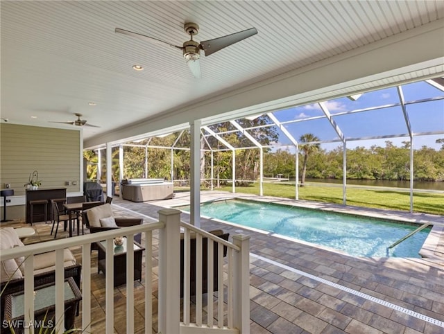 pool with a patio, a ceiling fan, glass enclosure, and a hot tub