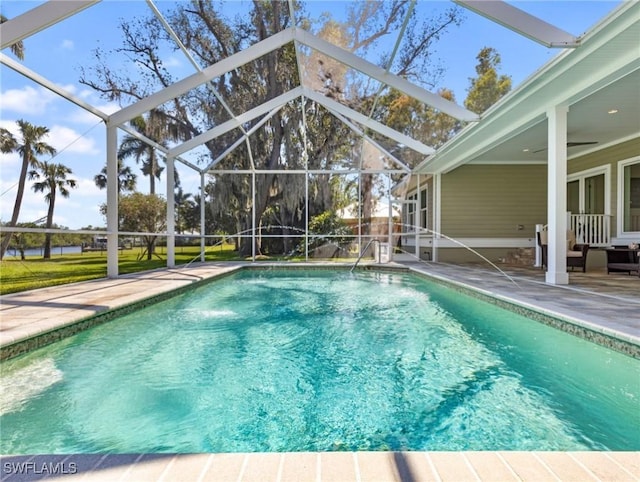 outdoor pool featuring a patio area, a lanai, and a ceiling fan