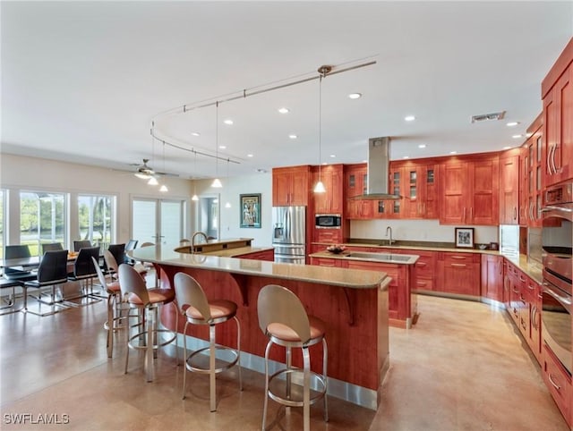 kitchen featuring recessed lighting, stainless steel appliances, visible vents, a large island, and island exhaust hood