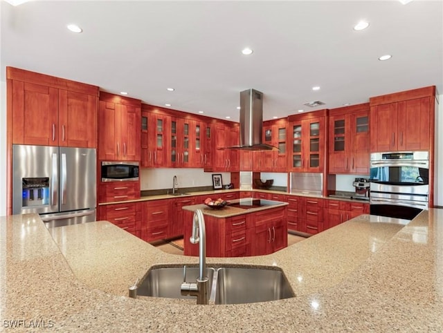 kitchen featuring stainless steel appliances, recessed lighting, a sink, and island range hood